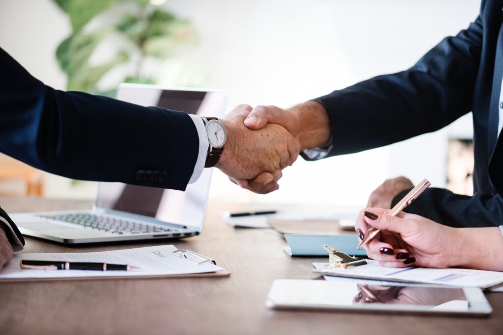 An image of two men shaking hands at a job interview.