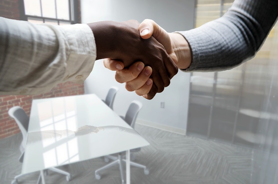 An image of a recruiter and a candidate meeting for the first time for an interview.