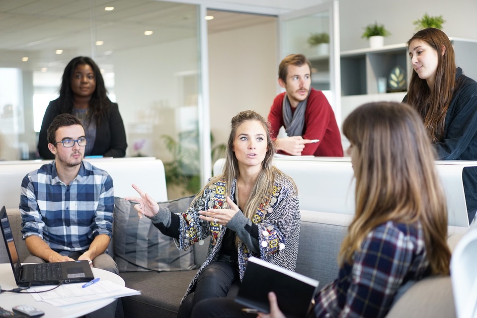 An image of six people in an office environment, having a meeting.